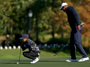 Tiger Woods and son Charlie Woods line up a putt on the 18th hole during the Pro-Am for the PNC Championship at the Ritz Carlton Golf Club on December 18, 2020 in Orlando.