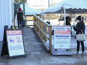 People line up at a COVID-19 assessment centre during the COVID-19 pandemic in Scarborough, Ont., on Wednesday, Dec. 2, 2020.