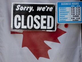 A "closed" sign hangs in a store window in Ottawa, Thursday April 16, 2020.