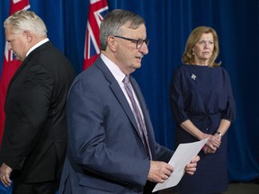 Dr. David Williams, Ontario's Chief Medical Officer (centre) Premier Doug Ford and Health Minister Christine Elliott attend a news conference at the Ontario Legislature in Toronto on Wednesday November 25, 2020.