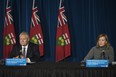 Deputy Premier and Minister of Health Christine Elliott responds to a question as Ontario Premier Doug Ford listens during a press conference at Queen's Park in Toronto on Friday, December 11, 2020.