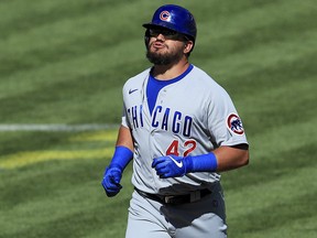 Chicago Cubs' Kyle Schwarber reacts after hitting a grand slam against the Cincinnati Reds in Cincinnati, Sunday, Aug. 30, 2020.
