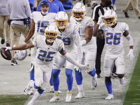 Chargers cornerback Chris Harris (25) reacts after intercepting the ball late in the second half against the Raiders at Allegiant Stadium in Las Vegas, Thursday, Dec. 17, 2020.