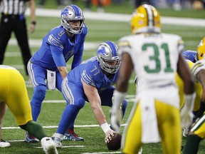 Detroit Lions quarterback Matthew Stafford (9) waits for the snap from centre Frank Ragnow (77) against the Green Bay Packers at Ford Field.