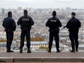 French police and riot police patrol in Montmartre in Paris after France raised the security alert to the highest level after a knife attack in the city of Nice, Oct. 30, 2020.