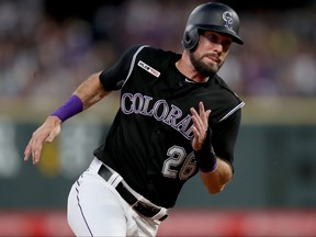 David Dahl of the Colorado Rockies rounds third base to score on a Nolan Arenado single in the fifth inning against the Los Angeles Dodgers at Coors Field on July 29, 2019 in Denver, Colorado.