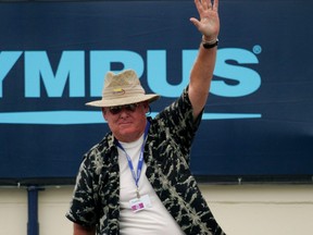 Former tennis player Dennis Ralston waves to the crowd as he is acknowledged during the semifinals of the Countrywide Classic on July 29, 2006 in Straus Stadium at the Los Angeles Tennis Center-UCLA in Westwood, California.