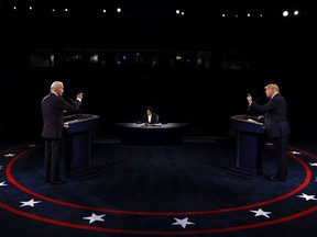 Moderator Kristen Welker,&ampnbsp;centre, of NBC News, listens as President Donald Trump and Democratic presidential candidate, former Vice President Joe Biden, participate in the final presidential debate at Belmont University,&ampnbsp;in Nashville, Tenn., Thursday, Oct. 22, 2020.