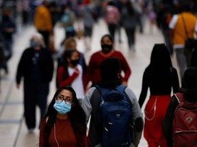 People walk on the street as the coronavirus disease (COVID-19) outbreak continues in Mexico City, Mexico, December 7, 2020.