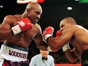WBA Heavyweight Champion Evander Holyfield (right) connects to the jaw of Mike Tyson in the first round of their title fight in Las Vegas, June 28, 1997.