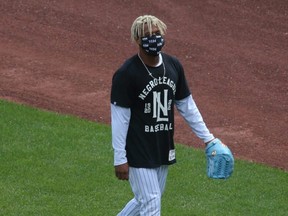 Mets pitcher Marcus Stroman walks across the field wearing a Negro Leagues t-shirt during summer camp workouts at Citi Field in Flushing Meadows, N.Y., July 15, 2020.