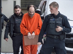 Matthew Raymond is escorted from provincial court in Fredericton on Friday, Feb. 8, 2019.