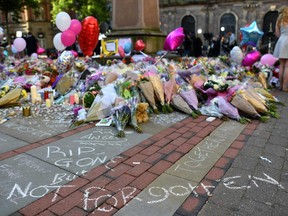 Flowers, messages and candles are pictured in St Ann's Square in Manchester, England on May 25, 2017, placed in tribute to the victims of the May 22 terror attack at the Manchester Arena.