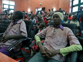 Rescued Nigerian school boys sit together at the Government house in Katsina, Nigeria, Friday, Dec. 18, 2020.