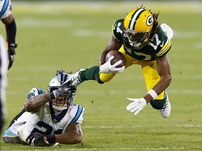 Green Bay Packers wide receiver Davante Adams (17) is tackled by Carolina Panthers safety Jeremy Chinn (21) after catching a pass at Lambeau Field.