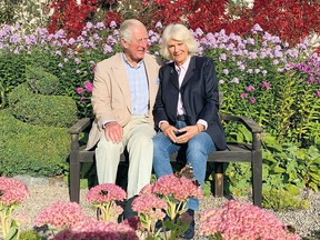 This undated handout picture released by Clarence House on December 16, 2020, shows Prince Charles and Camilla, Duchess of Cornwall posing for their 2020 Christmas card at Birkhall in Aberdeenshire, Scotland.