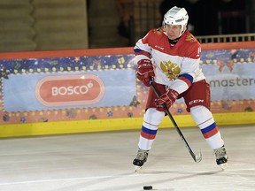 Russian President Vladimir Putin plays hockey at the ice rink on Red Square in Moscow, Russia December 21, 2020.