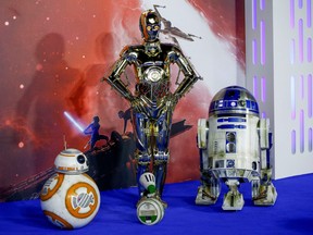 Star Wars robots R2-D2 and BB8 and droids C3PO and D-O pose as they attend the premiere of "Star Wars: The Rise of Skywalker" in London, Dec. 18, 2019.