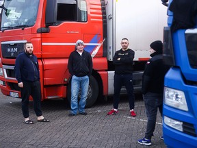 Lorry drivers from Poland speak with each other while they wait to leave the Ashford International Truck Stop, in Ashford, Britain December 22, 2020.