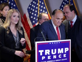 Trump Campaign Senior Legal Advisor Jenna Ellis speaks as Trump campaign advisor Boris Epshteyn whispers to former New York City Mayor Rudy Giuliani, personal attorney to U.S. President Donald Trump, during a news conference about the 2020 U.S. presidential election results at Republican National Committee headquarters in Washington, U.S., November 19, 2020.