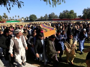 Afghan men carry the coffin of journalist Malalai Maiwand, who was shot and killed by unknown gunmen in Jalalabad, Afghanistan December 10, 2020.