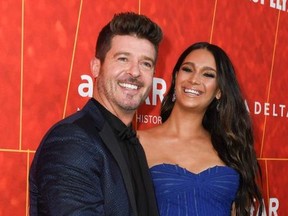 US singer/songwriter Robin Thicke and partner Mexican model April Love Geary arrives at the amfAR Gala Los Angeles at the Wallis Annenberg Center for the Performing Arts on October 18, 2018 in Beverly Hills.