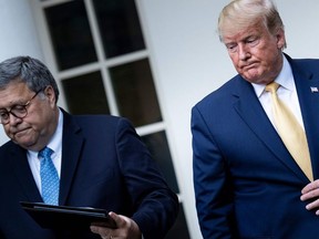 In this file photo taken on July 11, 2019 US President Donald Trump (L) and US Attorney General William Barr arrive to deliver remarks on citizenship and the census in the Rose Garden at the White House in Washington, DC. - US President Donald Trump on December 14, 2020 said Attorney General Bill Barr, who contradicted his claims that the November 3 election was marred by fraud, would leave office after doing an "outstanding job." (Photo by Brendan Smialowski / AFP)