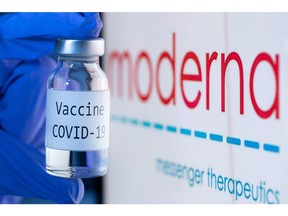 This file photo taken on Nov. 18, 2020 shows a bottle reading "Vaccine COVID-19" next to the Moderna biotech company logo.