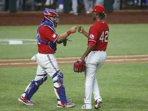 Texas Rangers catcher Jose Trevino (left) congratulates relief pitcher Rafael Montero (left) after the game against the Los Angeles Dodgers at Globe Life Field.