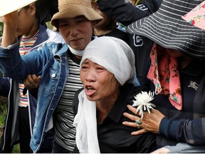 Tran Thi Hien, mother of Anna Bui Thi Nhung, one of 39 Vietnamese people found dead in a truck near London last year, cries while following an ambulance carrying her daughter's coffin during the funeral ceremony at her village in Nghe An province, Vietnam November 30, 2019.