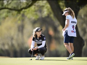 Brooke Henderson (left) looks over her putt with caddie Ellen Brittany on the 13th hole during the first round at the 2020 U.S. Women's Open at Champions Golf Club (Jackrabbit Course) in Houston, Texas on Thursday, Dec. 10, 2020.