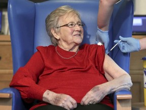 Resident Annie Innes, 90, receives the Pfizer BioNTech COVID-19 vaccine at the Abercorn House Care Home in Hamilton, Scotland, Monday Dec. 14, 2020.
