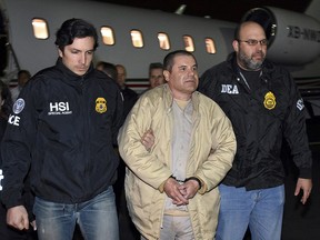 In this Jan. 19, 2017 file photo provided by U.S. law enforcement, authorities escort Joaquin "El Chapo" Guzman from a plane at Long Island MacArthur Airport, in Ronkonkoma, N.Y. (U.S. law enforcement via AP, File)