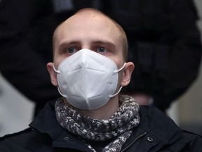 Stephan Balliet, who is accused of shooting dead two people after an attempt to storm a synagogue in Halle an der Saale, wears a face mask as he waits for the start of the trial at the district court in Magdeburg, Germany, December 21, 2020.