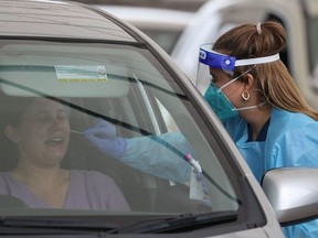 A medical worker swabs a member of the public at the Bondi Beach drive-through coronavirus disease (COVID-19) testing centre as the city experiences an outbreak in Sydney, Australia, December 21, 2020.