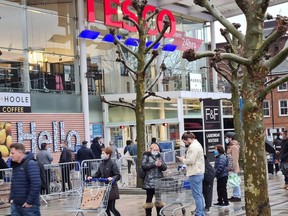 Customers queue outside a Tesco supermarket amid the coronavirus disease (COVID-19) outbreak in London, Britain December 21, 2020 in this picture obtained from social media.