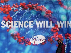 A person walks past the Pfizer Headquarters building in the Manhattan borough of New York City, New York, U.S., December 7, 2020.