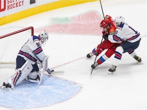 CP-Web. United States goalie Spencer Knight (30) makes the save on Russia's Vasili Podkolzin (19) as Brock Faber (11) defends during first period IIHF World Junior Hockey Championship action in Edmonton, Friday, Dec. 25, 2020.