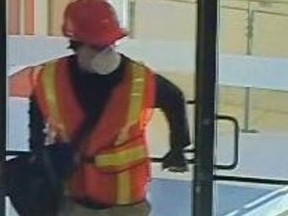 Michael Karas is pictured while robbing a CIBC branch in Waterloo. When hunting for Karas, Waterloo police issued a tweet containing this image.