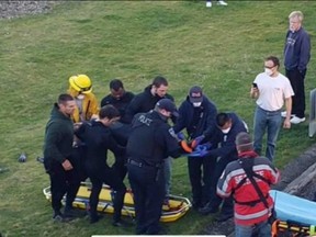 Crews from Seaside Fire & Rescue, Seaside Police and Medix assist shark bite victim.