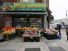 Grocery and plant shopping along curbside markets on College St. W. and Montrose Ave. in Little Italy on Thursday March 26, 2020.