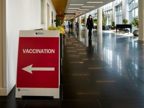 A sign directs healthcare workers to a rehearsal for the administration of the Pfizer COVID-19 vaccine at Indiana University Health in Indianapolis, Monday, Dec. 11, 2020.