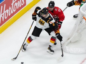 Jakob Pelletier (No. 12) of Canada skates against Tim Stutzle (No. 8) of Germany during the 2021 IIHF World Junior Championship at Rogers Place on December 26, 2020.