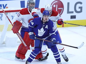 Ben Chiarot #8 of the Montreal Canadiens drills Auston Matthews #34 of the Toronto Maple Leafs in the back during an NHL game at Scotiabank Arena on January 13, 2021 in Toronto.
