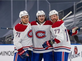 Canadiens forward Jake Evans (left) celebrates with defence partners Alexander Romanov and Brett Kulak following a goal in 3-1 victory over the Oilers on Jan. 18 in Edmonton.