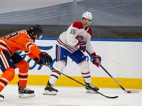 Oiler's Alex Chiasson defends against Canadiens' Jesperi Kotkaniemi Monday night in Edmonton. Kotkaniemi is one of the players Montreal has stashed on the taxi squad this season to save money against the salary cap.