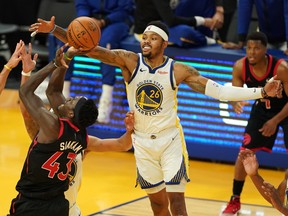 Golden State Warriors forward Kent Bazemore blocks a shot by Toronto Raptors forward Pascal Siakam on Sunday.