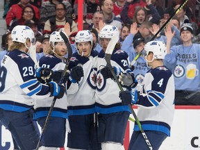 The Winnipeg Jets celebrate a goal scored by centre Mark Scheifele (55) in the first period against the Ottawa Senators at the Canadian Tire Centre. The Jets will be on the ice for training camp on Monday. Marc DesRosiers-USA TODAY Sports