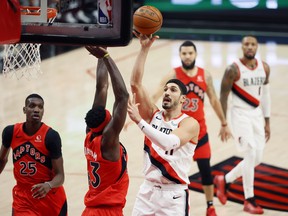 Portland Trail Blazers centre Enes Kanter (11) shoots the ball over Toronto Raptors power forward Pascal Siakam (43) during the first half at Moda Center.