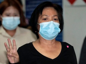 Anchan Preelert gives a three-finger salute while leaving court after being sentenced to 43 years in jail for sharing online posts criticizing the royal family, in Bangkok, Thailand, Tuesday, Jan. 19, 2021.